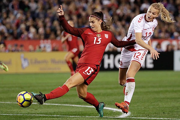 U.S. forward Alex Morgan shoots on goal as Denmark forward Stine Larsen defends during the second half of Sunday's international friendly in San Diego.