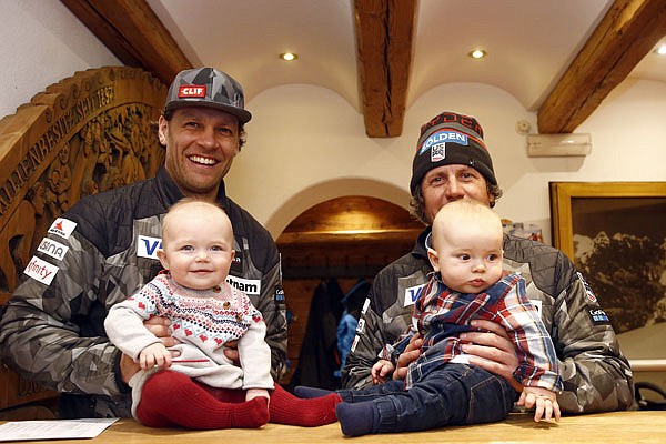 From left, United States' Steven Nyman holds his daughter Nell and head coach Sasha Rearick holds his son Giacomo as they pose for a photograph last Friday in Kitzbuehel, Austria.