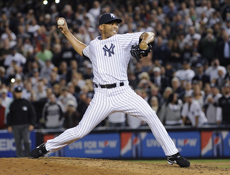 In this Sept. 26, 2013, file photo, New York Yankees reliever Mariano Rivera throws to a Tampa Bay Rays batter during the eighth inning of a baseball game at Yankee Stadium in New York. Rivera was making his final appearance at home for the Yankees. It could be another crowded Hall of Fame ceremony in 2019. After four players were voted in this year by the BBWAA, Rivera and Roy Halladay headline next year's ballot. (AP Photo/Bill Kostroun, File)