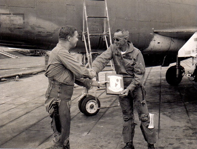 Lt. Col. Don Pittman, left, receives a plaque after completing his final flight in Vietnam on May 1, 1968. During his two tours in Vietnam, the command pilot accrued 385 combat hours in an F-100D Super Sabre.