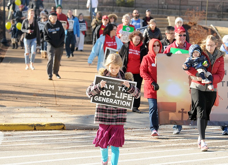 Participants in the eighth annual Midwest March for Life make their way back to the Capitol after completing the march Saturday morning through parts of downtown. They then gathered for a rally in the Capitol Rotunda.