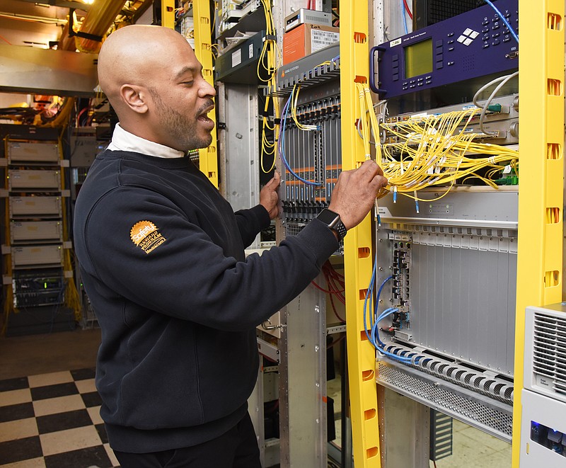Derrick Smith explains the ins and outs of the headend facility which routes signals and allows them to travel faster on Midiacom's broadband Internet network. Smith is HFC (hybrid fiber-coaxial) supervisor for Mediacom.