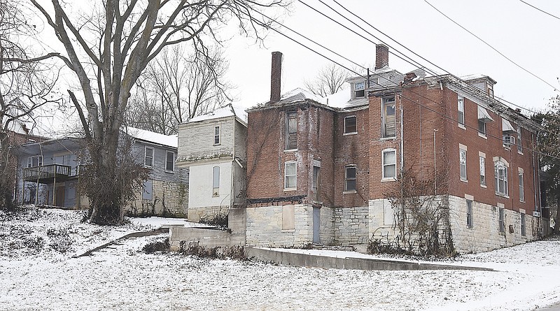 File Photo: The buildings at 101 through 105 Jackson St., the backsides of which are shown here, 101 Jackson St., at right, to 105 Jackson St., blue building at left, are the subject of a condemnation civil suit filed by the Jefferson City Housing Authority.