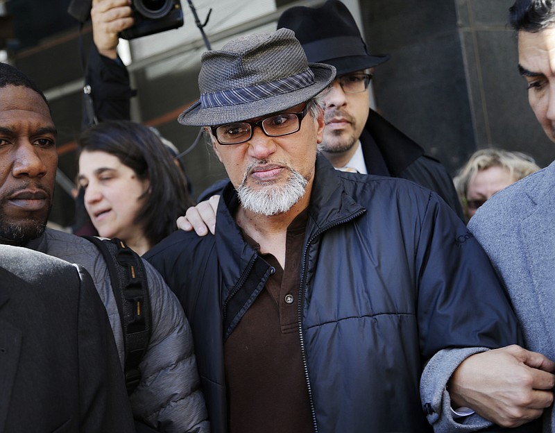 File-This March 9, 2017, file photo shows Ravi Ragbir, executive director of the New Sanctuary Coalition, being escorted by supporters after his annual check-in with Immigration and Customs Enforcement, in New York. U.S. Rep. Nydia Velazquez has invited the wife of detained immigrant rights activist Ravi Ragbir to President Donald Trump's State of the Union address. Ragbir was in federal custody Saturday, several weeks after he was arrested during a routine check-in with the Immigration and Customs Enforcement agency. On Saturday, Velazquez, a Democrat, joined Ragbir's wife, Amy Gottlieb, and other elected officials at a rally in front of the Manhattan office building that houses ICE.  (AP Photo/Seth Wenig, File)