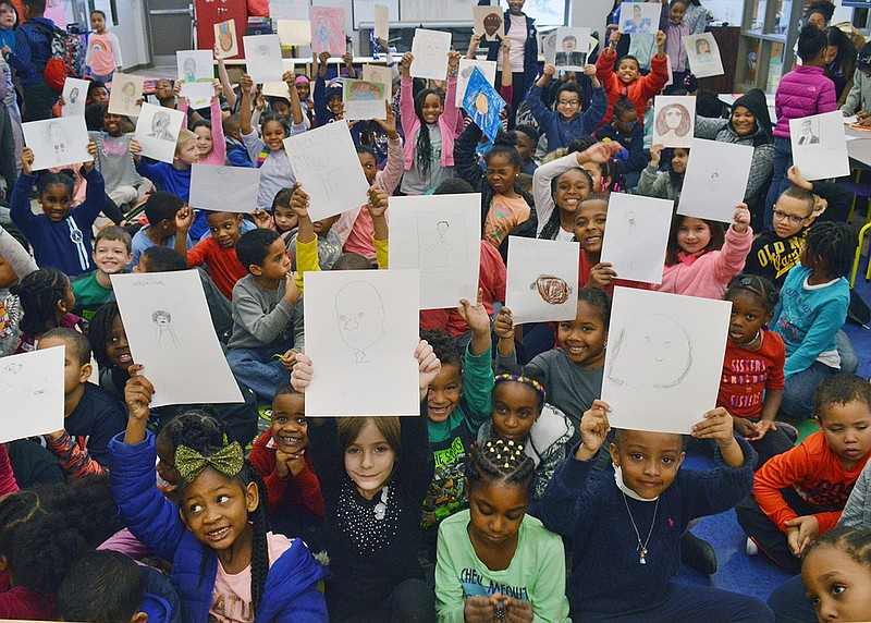 Children at the Boys & Girls Club of Jefferson City show off their artwork of influential African-Americans to representatives from the Boys & Girls Club and local U.S. Cellular representatives Tuesday.