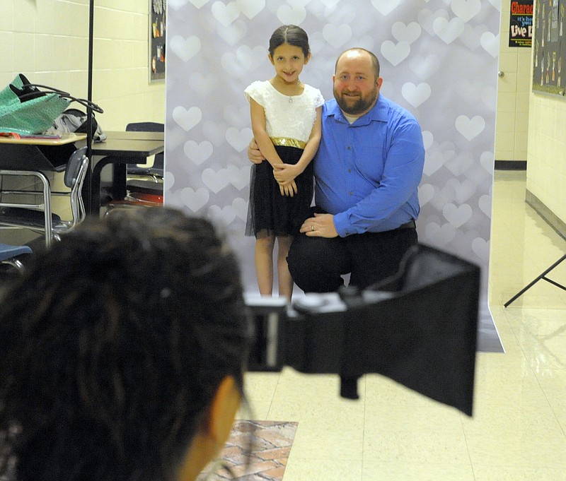 <p>Democrat photo/Michelle Brooks</p><p>Elizabeth Sullivan, 8, and her dad, Matt Sullivan, had their photo taken by Portraits by Shawnna, who donated her time and equipment for the dance.</p>