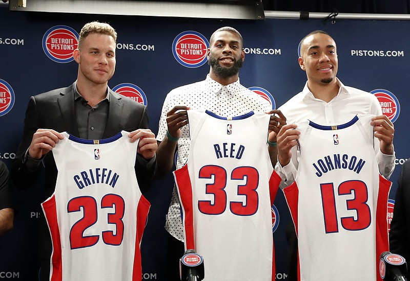 Detroit Pistons' Blake Griffin, from left, Willie Reed and Brice Johnson pose with their new NBA basketball uniforms in Auburn Hills, Mich., Wednesday, Jan. 31, 2018. (AP Photo/Paul Sancya)