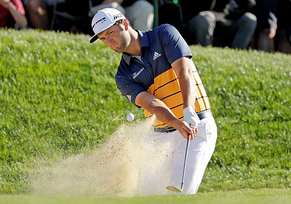 Jon Rahm hits out of a bunker on the 13th hole of the South Course at Torrey Pines Golf Course during the third round of the Farmers Insurance Open on Saturday in San Diego.