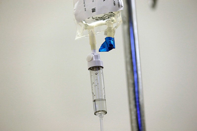 In this May 25, 2017 file photo, chemotherapy drugs are administered to a patient at North Carolina Cancer Hospital in Chapel Hill, N.C. Health experts are stepping up warnings as more cardiac side effects of some breast cancer treatments come to light. In its first guidance on the issue, released on Thursday, Feb. 1, 2018, the American Heart Association urges that women and their doctors carefully weigh the risks and benefits of any therapy that may cause heart damage. (AP Photo/Gerry Broome)