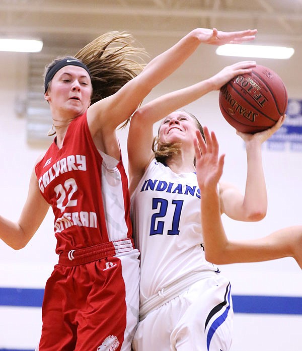 Jayla Volkart of Russellville attempts a shot against Katy Allen of Calvary Lutheran during Thursday night's game in Russellville.