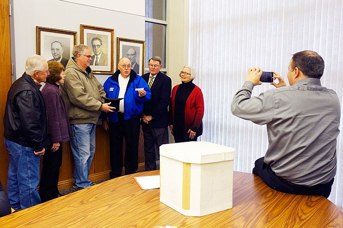 Fulton Mayor LeRoy Benton (center) picks a name of a president out of an antique top hat Thursday morning at city hall. The chosen president will be the topic of this year's Kingdom of Callaway Historical Society's trivia contest Feb. 24. Helping with the ceremony are Jim Buffington (left), Barb Huddleston, Bryant Liddle, Benton, Joe Holt and Susan Krumm, with Darin Wernig, city of Fulton public information guy, taking pictures.