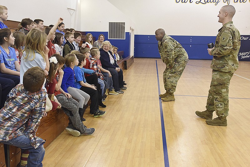 Sgt. 1st Class Ingram Cephus listens to student's ask about the Army. Cephus and Staff Sgt. Nicholas Frank visited students at Our Lady of Snows Catholic School on Monday during a assembly.
