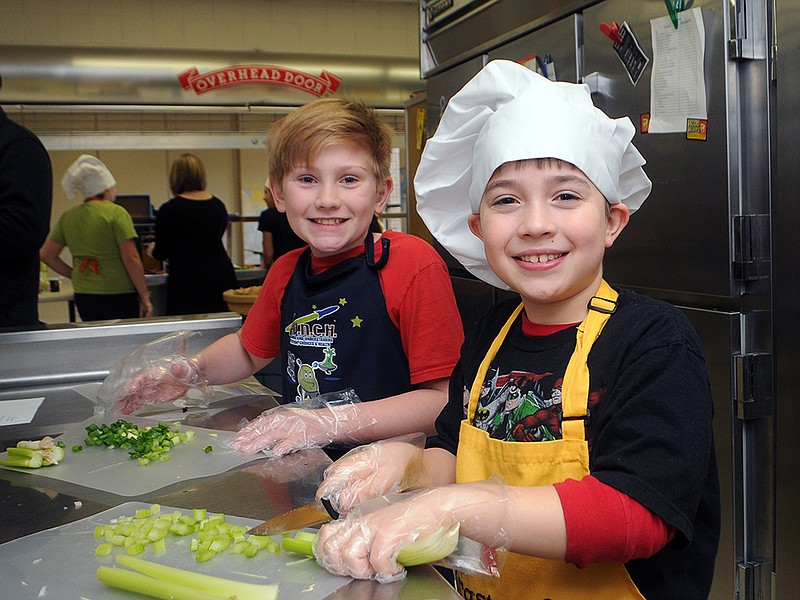 Justin Isaacs, left, and Gavin Wilson create a loaded chicken salad Wednesday, Jan. 31, 2018, during the Callaway Hills Elementary School Cooking Club.