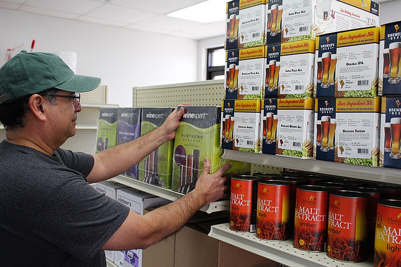 Francisco "Pancho" Lozano stocks the shelves at Pancho's Brewing Lab. Texarkana's home brewing community is small but growing, and Pancho's will have a range of items available for hobbyists.