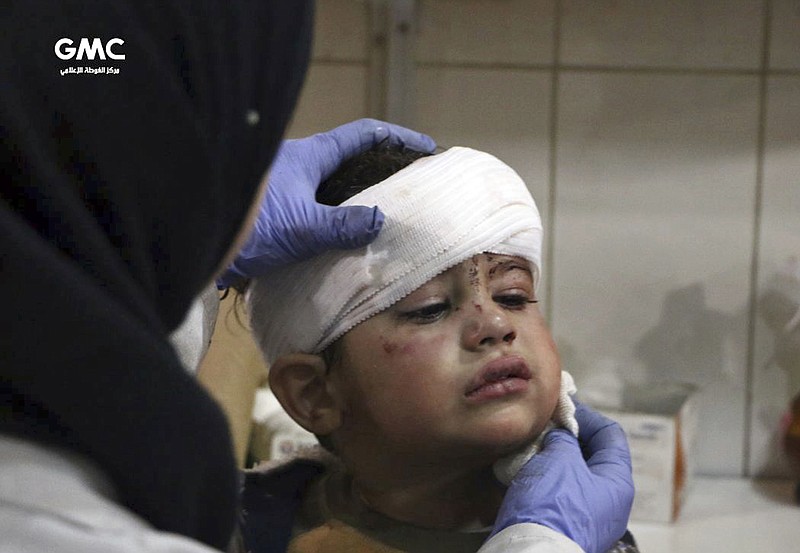 This photo provided by the Syrian anti-government activist group, Ghouta Media Center, GMC, which has been authenticated based on its contents and other AP reporting, shows an injured boy receiving treatment at a hospital in Hazeh in eastern Ghouta, the only remaining rebel stronghold near the capital, Damascus, Syria, Monday, Feb. 5, 2018. The Syrian Observatory for Human Rights says waves of airstrikes hit at least five neighborhoods in the eastern Ghouta suburb. (Ghouta Media Center via AP)