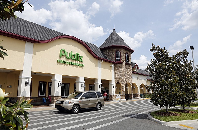 FILE-In this Sunday, May 19, 2013 file photo, a vehicle passes the front of the Publix supermarket in Zephyrhills, Fla. Publix announced a change Tuesday, Feb. 6, 2018 in a reply on Twitter to Florida state Rep. Carlos Guillermo Smith. The Orlando-area Democrat had met with Publix officials Monday to discuss their refusal to cover Truvada for PrEP. The 6-year-old drug is more than 95 percent effective in preventing the contraction of human immunodeficiency virus, which can cause AIDS.(AP Photo/Scott Iskowitz, File)