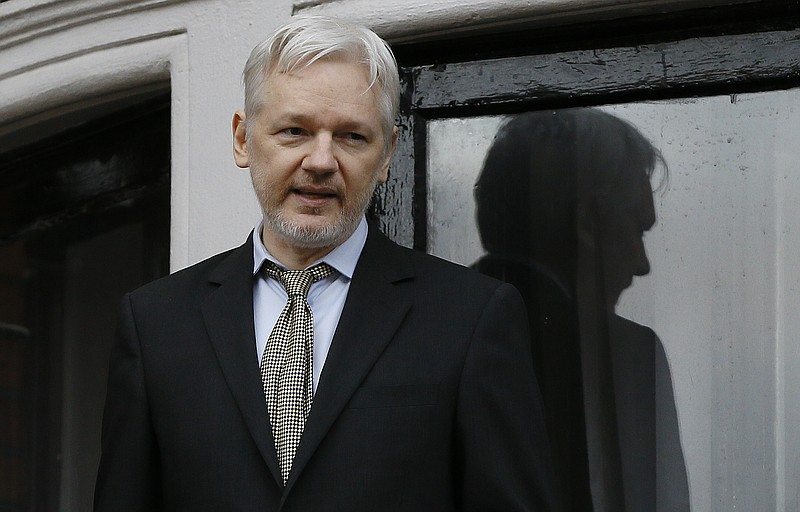 FILE - In this Feb. 5, 2016 file photo, WikiLeaks founder Julian Assange speaks from the balcony of the Ecuadorean Embassy in London.  A British judge  on Tuesday Feb. 6, 2018  upheld a U.K. arrest warrant for the WikiLeaks founder Julian Assange, leaving his legal position unchanged after more than five years inside the Ecuadorean Embassy. The judge says the warrant stands, rejecting a call from Assange's lawyers for the warrant to be revoked because he is no longer wanted for questioning in Sweden. (AP Photo/Kirsty Wigglesworth, File)