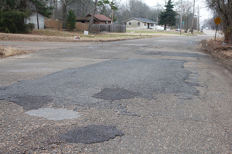 Patched pavement is shown Tuesday near Grim and Spencer streets in Texarkana, Ark. The Arkansas State Aid City Street program has granted the city $250,000 to repave Grim Street between Division Street and Forest Street, as well as East 19th Street between Northcutt Street and L.E. Gilliland Road. 

