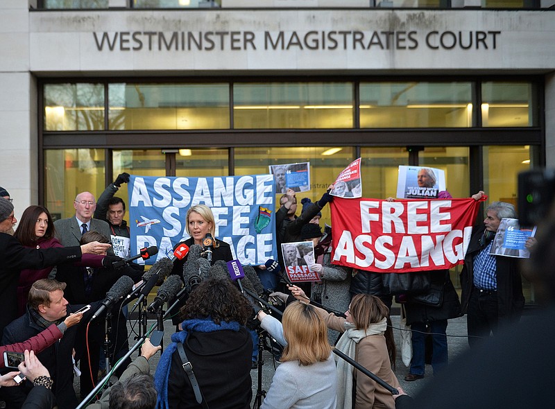 Jennifer Robinson, centre left, a lawyer representing Julian Assange, talks to the media outside Westminster Magistrates Court after the court ruled that an arrest warrant against Assange is still valid, in London, Tuesday Feb. 6, 2018.  Lawyers for the WikiLeaks founder argued that the warrant should be dismissed, but following the verdict Tuesday, Assange would seem likely to continue his shelter within the Ecuadorian embassy in London. ( John Stillwell/PA via AP)