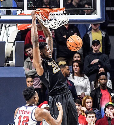 Jeremiah Tilmon of Missouri dunks next to Mississippi's Bruce Stevens during Tuesday night's game in Oxford, Miss.