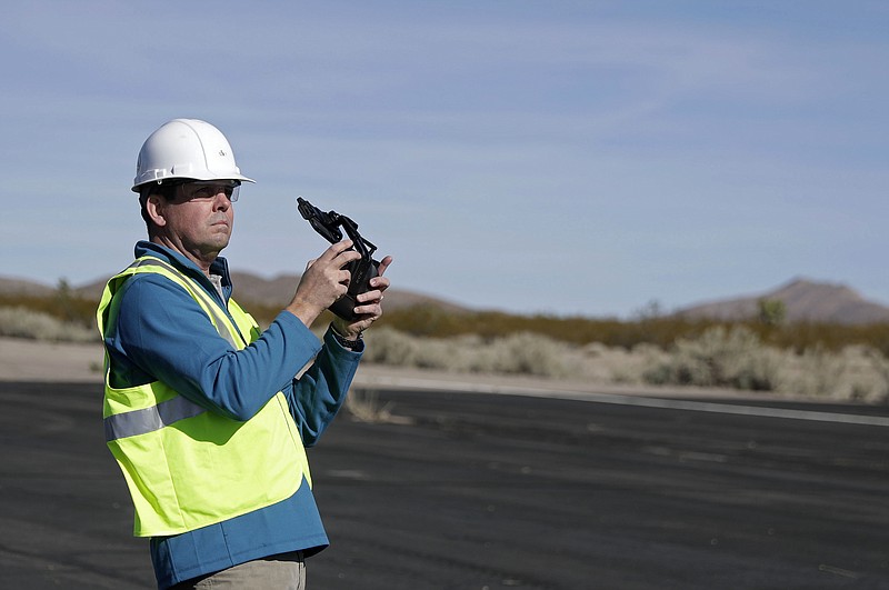 Keven Gambold, CEO of Unmanned Experts, demonstrates how to fly a drone at the Searchlight airport in Searchlight, Nev., on Wednesday, Jan. 17, 2018. Gambold, a hacking target, said the Russians might be counting on espionage to catch up with the Americans. "This would allow them to leapfrog years of hard-won experience," he said. (AP Photo/Isaac Brekken)