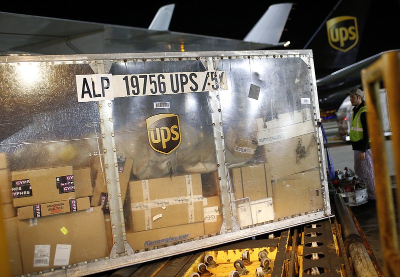 In this Nov. 20, 2015 picture, a UPS airplane is unloaded at the company's Worldport hub in Louisville, Ky. Shares of delivery companies FedEx and UPS are falling in Friday, Feb. 9, 2018, premarket trading following a report that powerhouse Amazon is readying its own delivery service for businesses.  (AP Photo/Patrick Semansky)