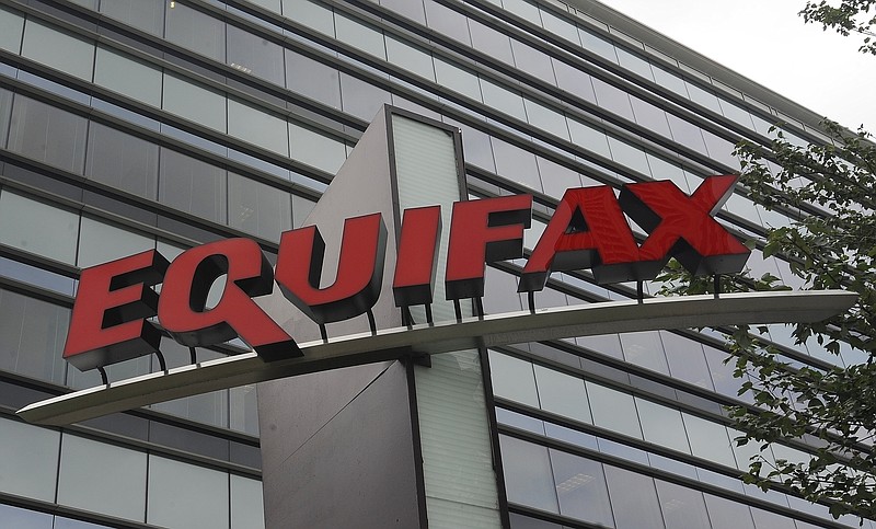 This Saturday, July 21, 201 file, photo shows signage at the corporate headquarters of Equifax Inc. in Atlanta. Equifax has disclosed to lawmakers that its data breach exposed more of consumers' personal information than the company first made public last year. The credit reporting company submitted paperwork to the Senate Banking Committee showing criminals accessed information such as tax identification numbers, email addresses, phone numbers and more, Friday, Feb. 9, 2018. (AP Photo/Mike Stewart, File)