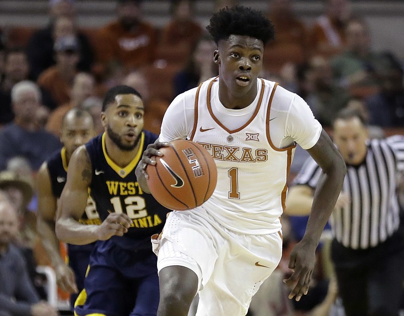 FILE - In this Jan. 14, 2017, file photo, Texas guard Andrew Jones (1) brings the ball up court during the second half of an NCAA college basketball game against West Virginia in Austin, Texas. The announcement that Jones was diagnosed with leukemia prompted concern and well wishes from across college basketball. He is now starting to offer glimpses of how he's coping with his treatment, and sending "thank you" messages for the emotional and financial support that have poured in to help. (AP Photo/Eric Gay, File)