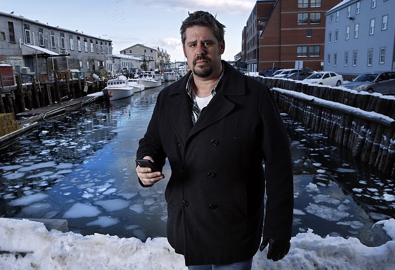 In this Thursday, Feb. 8, 2018 photo Jeremy DaRos, who received an erroneous tsunami alert on his phone, poses on the waterfront in Portland, Maine. "People need to trust the alerts they're pushing out," he said. "This is important stuff, and to have two incidents in the span of a month is just unacceptable." (AP Photo/Robert F. Bukaty)