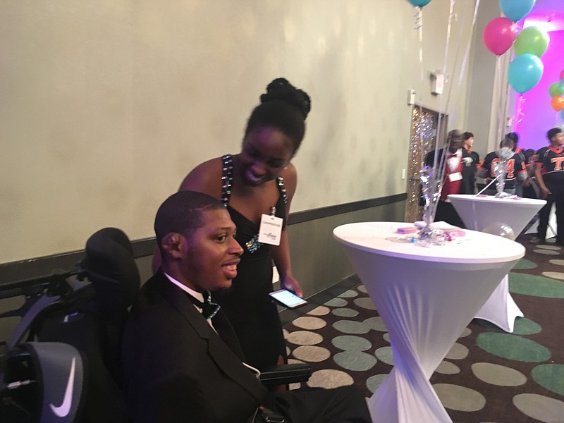 Chauncey Hooks, left, and his sister Chauzney Hooks enjoy a prom for teens and adults with special needs Friday night at the Texarkana, Ark., Convention Center. Chauncey Hooks attends Opportunities, Inc. programs.
