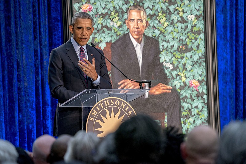 Former President Barack Obama, left, speaks at the unveiling ceremony for the Obama's official portraits at the Smithsonian's National Portrait Gallery, Monday, Feb. 12, 2018, in Washington. Obama's portrait was painted by Artist Kehinde Wiley. (AP Photo/Andrew Harnik)