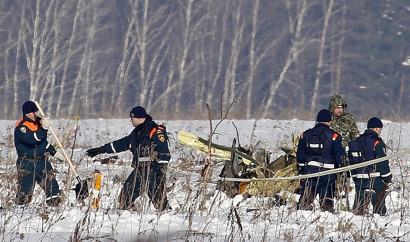 Personnel work at the scene of a AN-148 plane crash in Stepanovskoye village, about 40 kilometers (25 miles) from the Domodedovo airport, Russia, Monday, Feb. 12, 2018. A Russian passenger plane carrying 71 people crashed Sunday near Moscow, killing everyone aboard shortly after the jet took off from one of the city's airports. The Saratov Airlines regional jet disappeared from radar screens a few minutes after departing from Domodedovo Airport en route to Orsk, a city some 1,500 kilometers (1,000 miles) southeast of Moscow. (AP Photo/Alexander Zemlianichenko)