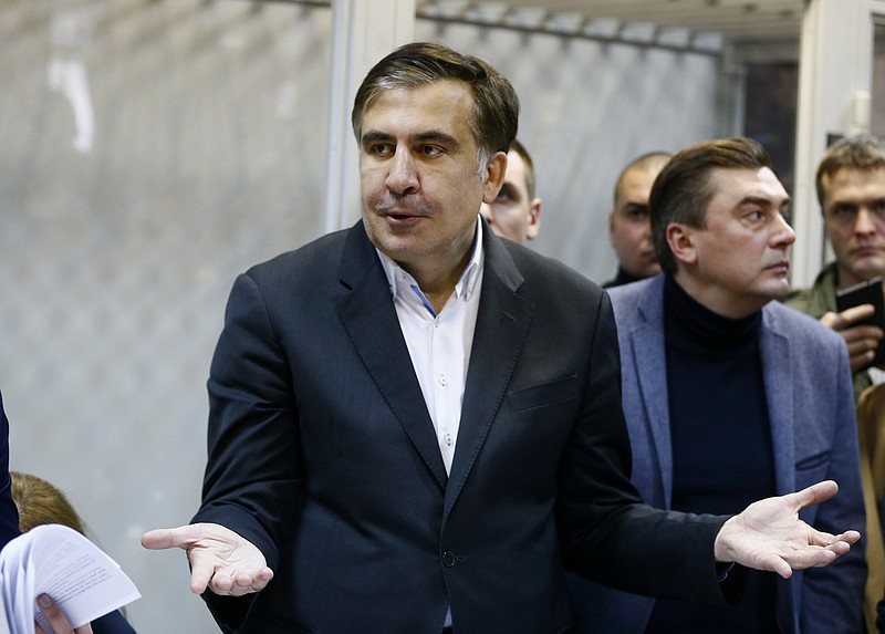 FILE - This is a Monday, Dec. 11, 2017  file photo of former Georgian President Mikheil Saakashvili as he gestures during a hearing in a court room in Kiev, Ukraine. Allies of Mikheil Saakashvili, the former Georgian president-turned opposition leader in Ukraine, say he was detained by masked men who they think acted on behalf of Ukrainian authorities. Saakashvili’s ally Liza Bogutskaya said on Facebook that Saakashvili was taken on Monday Feb. 12, 2018 and is being driven to the airport in the capital, Kiev. Other allies say authorities may try to deport him to Poland.  (AP Photo/Efrem Lukatsky/File)