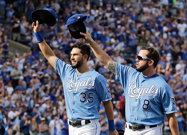 In this Oct. 1, 2017, file photo, Royals players Eric Hosmer and Mike Moustakas acknowledge the crowd as they come out of the game during the fifth inning of a game against the Diamondbacks in Kansas City.