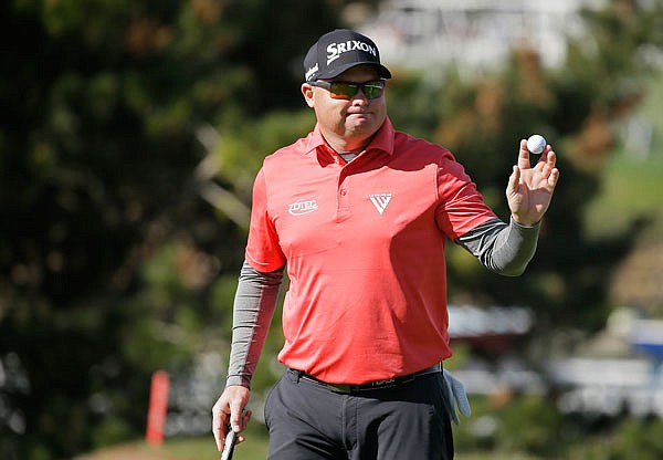 Ted Potter Jr. holds up his ball after making a birdie putt on the fourth green of the Pebble Beach Golf Links during Sunday's final round of the AT&T Pebble Beach National Pro-Am in Pebble Beach, Calif.