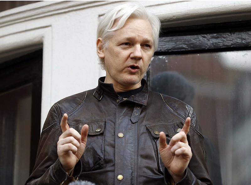 FILE - In this May 19, 2017 file photo, WikiLeaks founder Julian Assange gestures to supporters outside the Ecuadorian embassy in London, where he has been in self imposed exile since 2012. A British judge on Tuesday Feb. 13, 20-18 is scheduled to quash or uphold an arrest warrant for WikiLeaks founder Julian Assange, who has spent more than five years inside Ecuador's London embassy. Assange's lawyers argue that it's no longer in the public interest to arrest him for jumping bail in 2012. Assange was wanted in Sweden for a rape investigation when he sought protection in the Ecuadorean embassy. Swedish prosecutors dropped the case last year, but the British warrant still stands. (AP Photo/Frank Augstein, FILE)