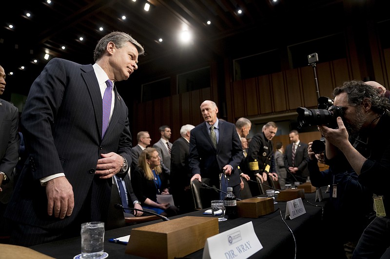 FBI Director Christopher Wray, left, and Director of National Intelligence Dan Coats, center, arrive for a Senate Select Committee on Intelligence hearing on worldwide threats, Tuesday, Feb. 13, 2018, in Washington. (AP Photo/Andrew Harnik)