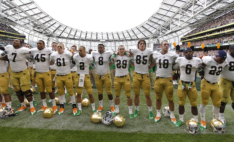 In this Sept. 1, 2012, file photo, Notre Dame players pose after the final whistle of their NCAA college football game against Navy, in Dublin, Ireland. The NCAA has denied Notre Dame's appeal of a decision to vacate 21 victories because of academic misconduct, including all 12 wins from the school's 2012 national championship game run. (AP Photo/Peter Morrison, File)