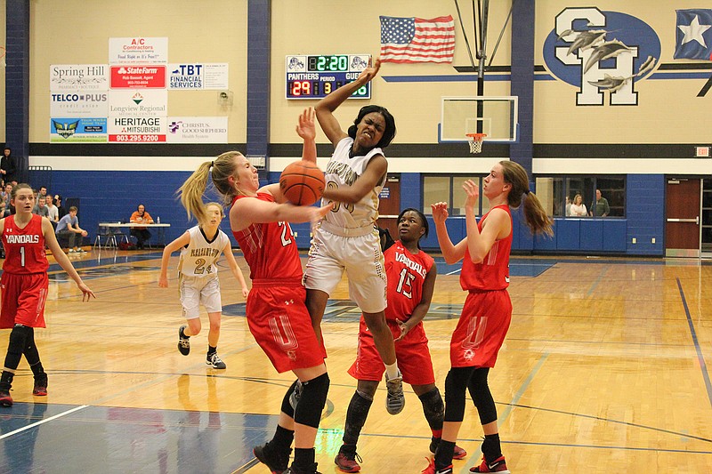 Pleasant Grove senior Monique Walker is fouled while going up for a shot against Van during a Class 4A bi-district girls basketball game Monday at Panther Gym in Longview, Texas. The Lady Hawks fell to the Lady Vandals, 67-40.