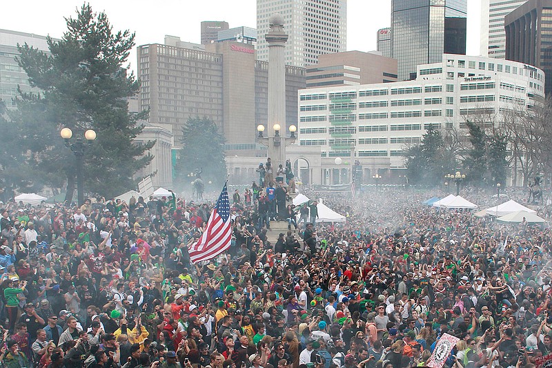 Associated Press
In this April 20, 2013, file photo, members of a crowd numbering tens of thousands smoke marijuana during the 4/20 pro-marijuana rally at Civic Center Park in Denver. According to a report released on Monday, the day marijuana users celebrate as their own holiday is linked with a slight increase in fatal U.S. car crashes, in an analysis of 25 years of data. Whether pot was involved in any April 20 crashes is not known, but the increased risk was similar in magnitude as found in previous research linking traffic accidents with Super Bowl Sunday.