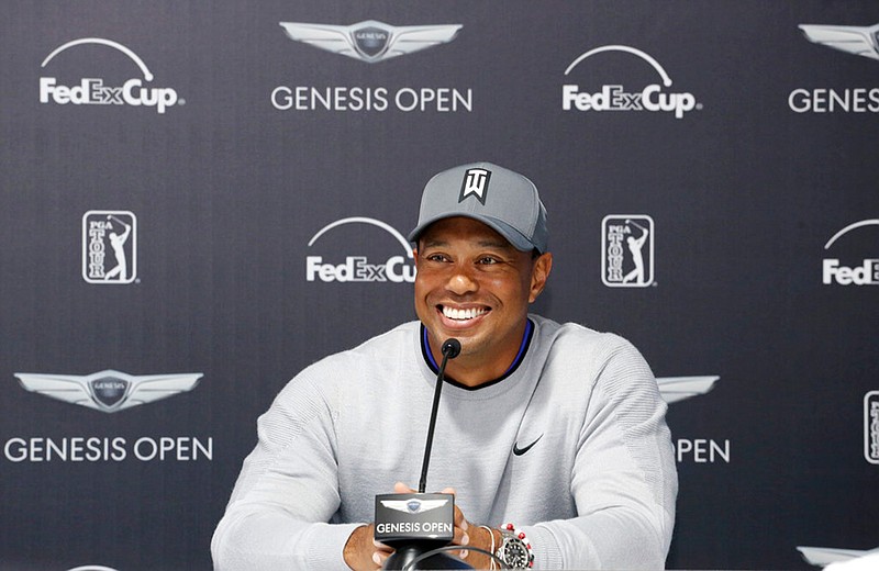 Tiger Woods talks about his charitable works off the course and his return to competitive golf in the Genesis Open at Riviera Country Club after an absence of 12 years, at the course in the Pacific Palisades area of Los Angeles Tuesday, Feb. 13, 2018. (AP Photo/Reed Saxon)