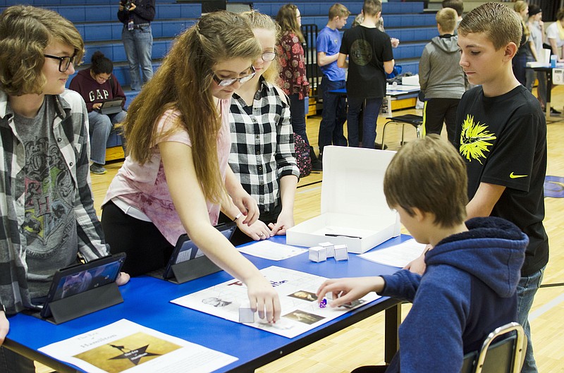 From left, South Callaway Middle School students Hannah Raley, Hannah Hoover and Karlee Bird watch over their game titled "The Era of Hamilton" on Thursday, Feb. 15, 2018, while Tyler Borgmeyer and Dylan Dugan play.