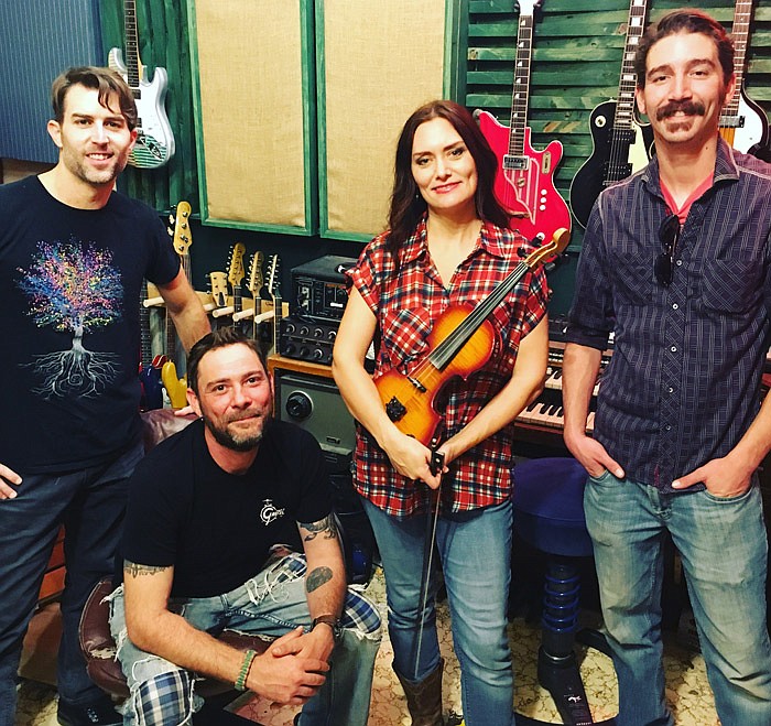 Molly Healey poses with her band.