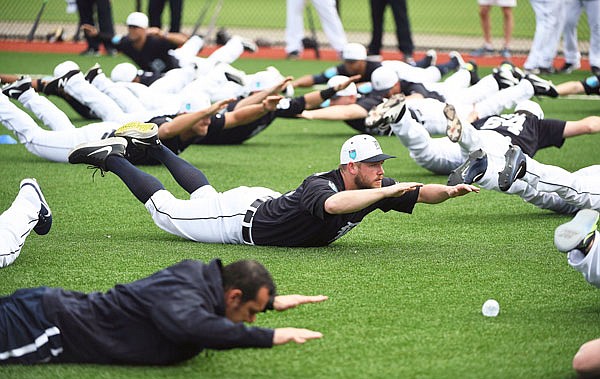 Tigers pitcher Alex Wilson does an exercise with the rest of the players during Wednesday's spring training practice in Lakeland, Fla.