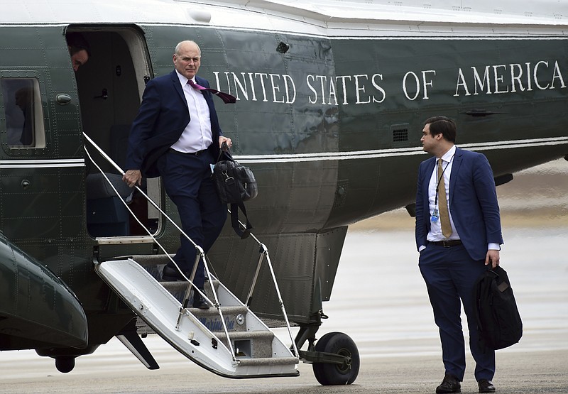White House Chief of Staff John Kelly, left, walks off of Marine One as White House aide Johnny DeStefano, right, waits, as they arrive at Andrews Air Force Base in Md., with President Donald Trump, Friday, Feb. 16, 2018. Trump is heading to Florida to spend the weekend at his Mar-a-Lago estate. (AP Photo/Susan Walsh)