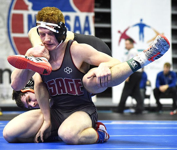 School of the Osage's Austin Magnuson grabs the legs of Owensville's Blaine Schoenfeld during Thursday's first round of the Class 2 state championships at Mizzou Arena.