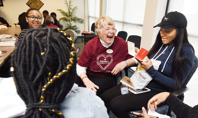 Evelyn Baur, middle, shares a laugh on Thursday with Lincoln University students, Caroline Wanjiru, background left, Latosheona Lucas, right, and Monya Smith, left. Baur is a resident at Primrose Retirement Community and was one of several who visited with students to spread random acts of kindness. 