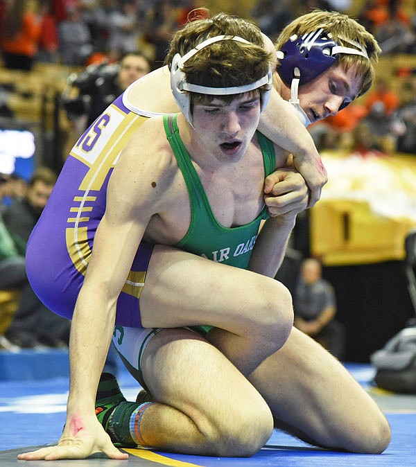 Blair Oaks' Ben Thomas attempts to escape the grasp of Hallsville's Luke West during Thursday's first round of the Class 1 state wrestling championships at Mizzou Arena.