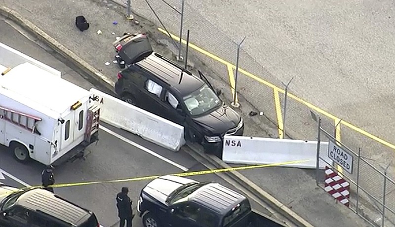 FILE -  In this file image made from video and provided by WUSA TV-9, authorities investigate the scene of a shooting at Fort Meade, Md. on Wednesday, Feb. 14, 2018.  A passenger in the vehicle that was fired on outside the National Security Agency campus says the unlicensed teen driver made a wrong turn, panicked and hit the gas. Passenger Javonte Alhajie Brown said on Friday, Feb. 16,  that the 17-year-old driver was following GPS directions to reach a friend’s house in a Maryland suburb. But he turned onto a restricted-access road that leads to the top-secret installation.  (WUSA TV-9 via AP)