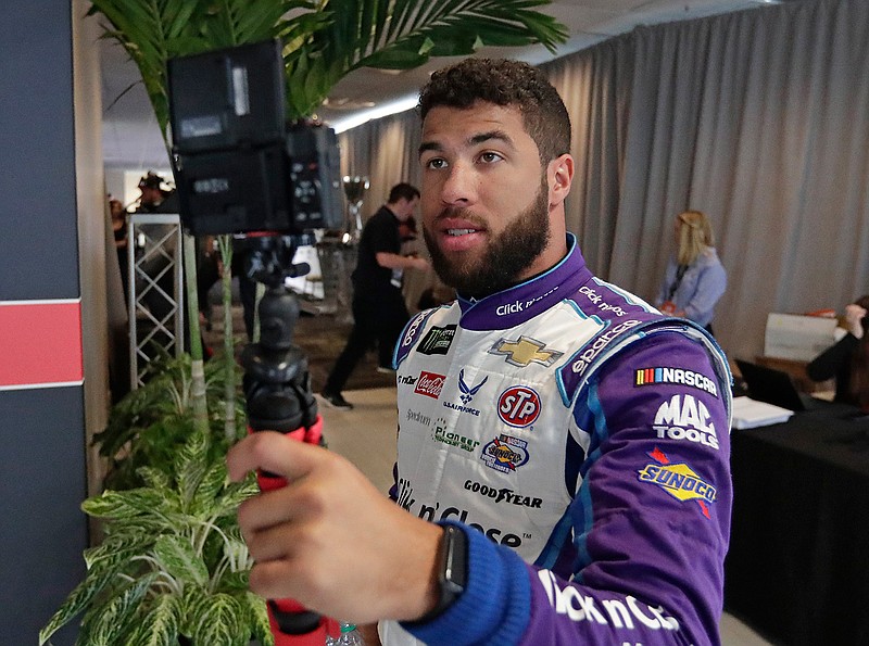 Darrell Wallace Jr. does a selfie video as he walks around during media day for the NASCAR Daytona 500 auto race at Daytona International Speedway, Wednesday, Feb. 14, 2018, in Daytona Beach, Fla. (AP Photo/John Raoux)